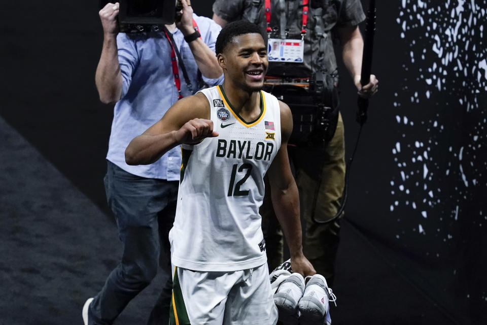 Baylor guard Jared Butler (12) celebrates as he walks off the court at the end of a men's Final Four NCAA college basketball tournament semifinal game against Houston, Saturday, April 3, 2021, at Lucas Oil Stadium in Indianapolis. Baylor won 78-59. (AP Photo/Darron Cummings)