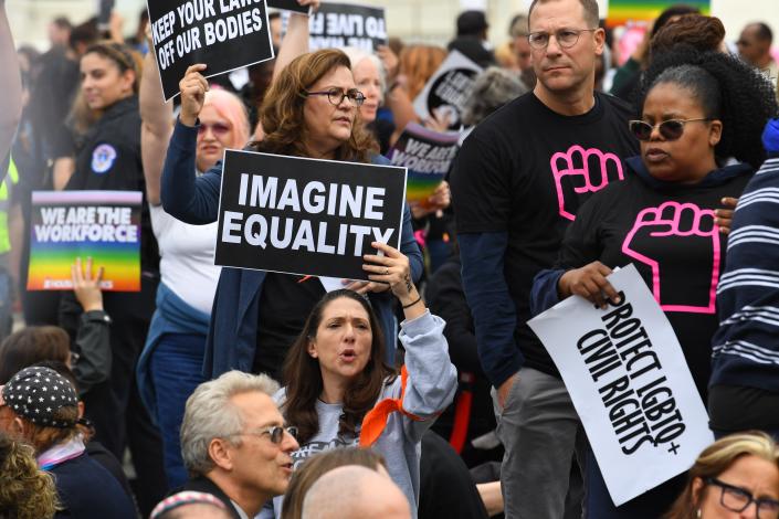 LGBTQ supporters gather in front of the U.S. Supreme Court on Oct. 8, 2019, as the justices hear three challenges from New York, Michigan and Georgia involving workers who claim they were fired because they were gay or transgender.