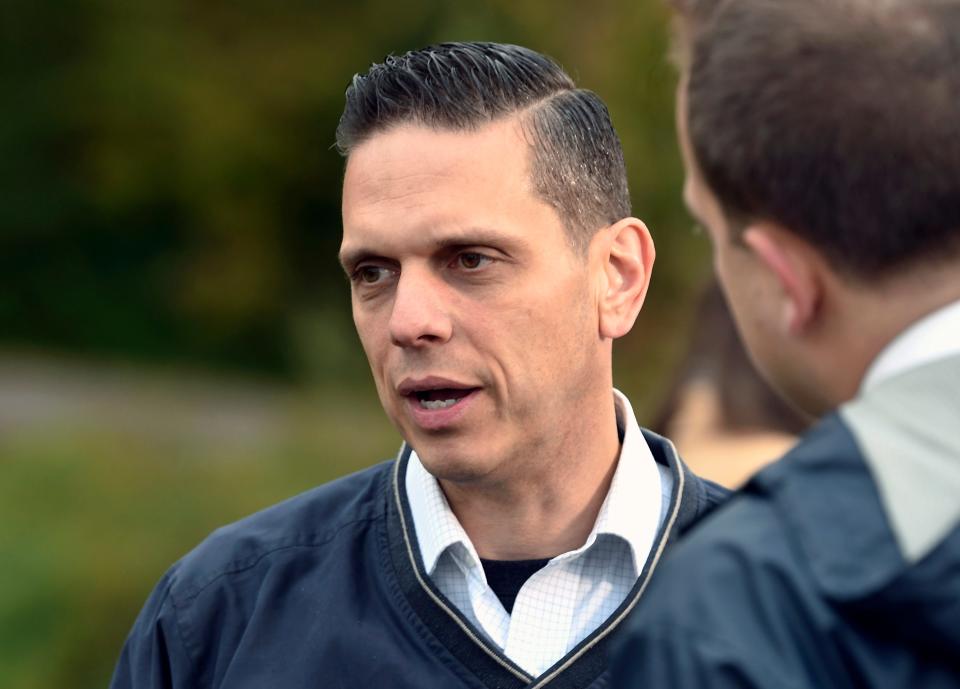 New York Assemblyman Angelo Santabarbara, D-Rotterdam, left, talks with reporters at a roadside memorial of a fatal limousine crash in Schoharie, N.Y., in Oct. 2018. Santabarbara is proposing legislation that would remove tolls on the New York State Thruway this summer, saying the move would be a relief for drivers burdened with inflation and high gas prices.