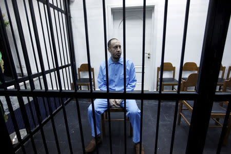 Saadi Gaddafi, son of Muammar Gaddafi, sits behind bars during a hearing at a courtroom in Tripoli, Libya November 1, 2015. REUTERS/Ismail Zitouny