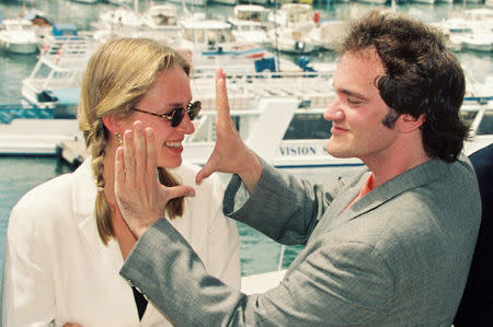 Actress Uma Thurman and director Quentin Tarantino pose during a photocall for their film "Pulp Fiction" in competition at the 47th Cannes Film Festival in Cannes, France, May 21, 1994. REUTERS/Eric Gaillard/File Photo