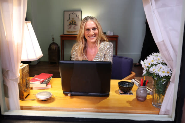 Sarah Jessica Parker sits at Carrie Bradshaw's famous desk at the Sex and the City Experience<p>Cindy Ord/Getty Images for Max®</p>