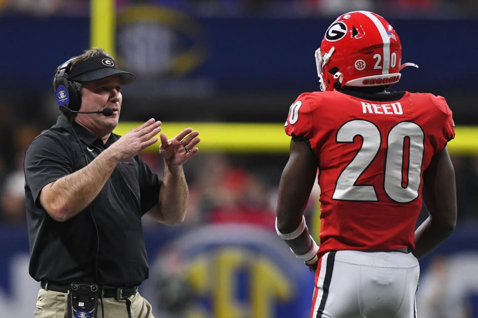 Georgia head coach Kirby Smart speaks to Georgia defensive back J.R. Reed (20) during the first half of the Southeastern Conference championship NCAA college football game against LSU, Saturday, Dec. 7, 2019, in Atlanta. (AP Photo/John Amis)