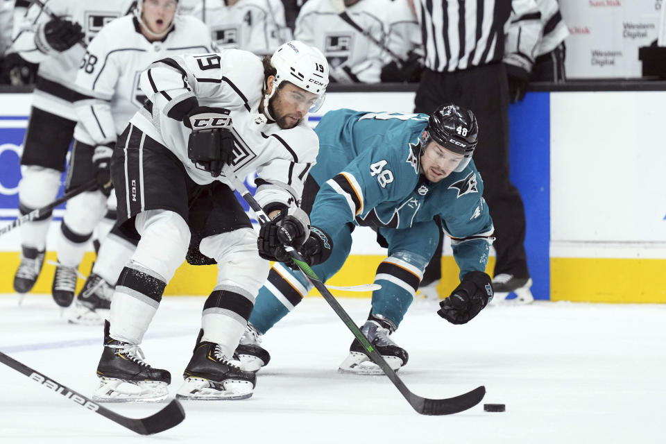 Los Angeles Kings left wing Alex Iafallo (19) skates with the puck while defended by San Jose Sharks center Tomas Hertl (48) during the second period of an NHL hockey game in San Jose, Calif., Monday, Jan. 17, 2022. (AP Photo/Darren Yamashita)