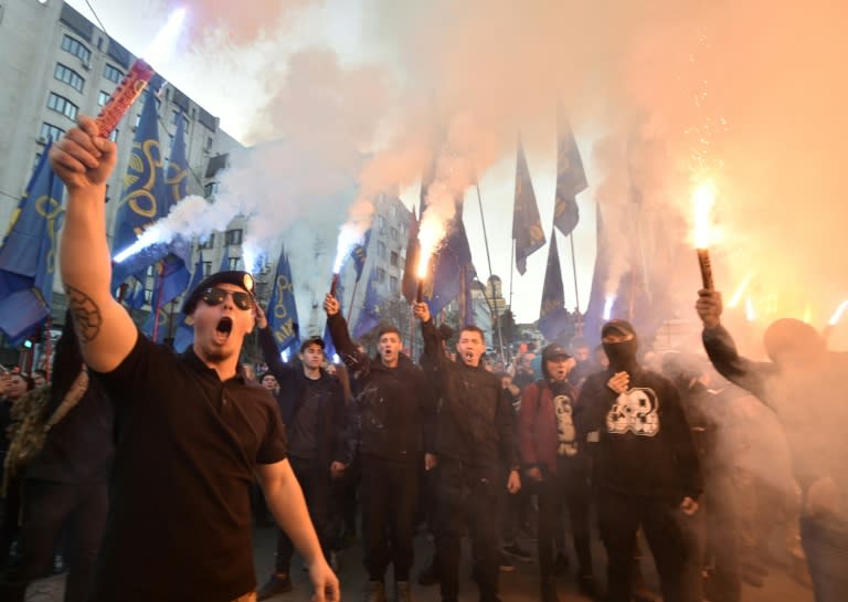 The demonstrators lit flares and smoke bombs while shouting "Glory to Ukraine!"