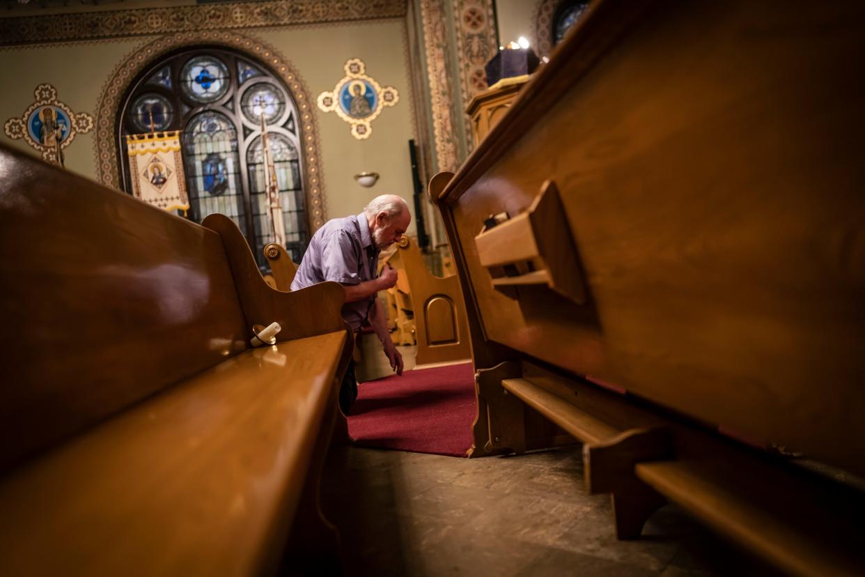 James McKeown kneels during a Good Friday service at St. Mary's Ukrainian Orthodox Cathedral in Allentown, Pa.