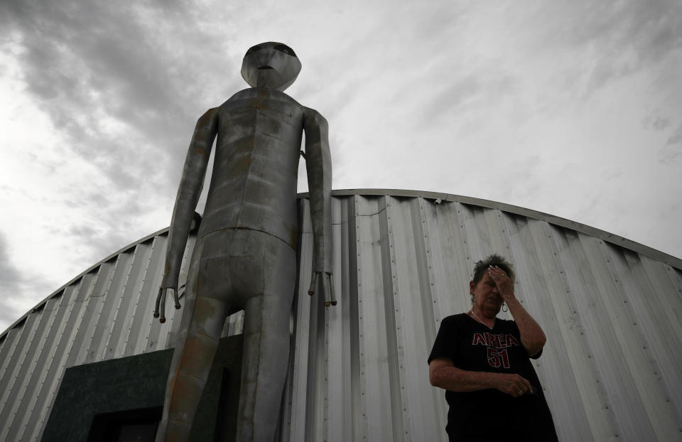 In this July 22, 2019 photo, Linda Looney wipes her face outside of the Alien Research Center, a gift shop on the Extraterrestrial Highway, in Crystal Springs, Nev. The U.S. Air Force has warned people against participating in an internet joke suggesting a large crowd of people "storm Area 51," the top-secret Cold War test site in the Nevada desert. "It was funny at first but now It's nuts," says Looney about all the interest in the facebook event. (AP Photo/John Locher)