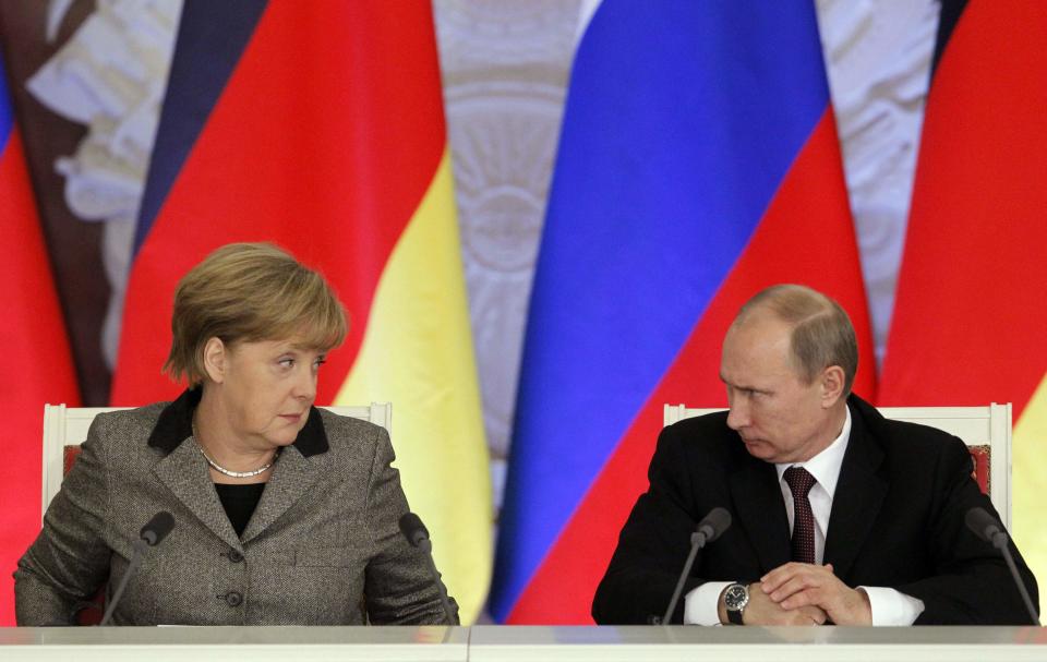 Russian President Vladimir Putin (R) and German Chancellor Angela Merkel look at each other while answering journalists' questions during a joint news conference in Moscow's Kremlin, in this November 16, 2012 file photo. Heavily dependent on Russian gas and closer to Moscow than any other leading western nation, Germany faces a major policy dilemma as the Ukraine crisis descends into a Cold War-style confrontation of tit-for-tat threats and ultimatums. For weeks, Merkel and her three-month old coalition government have gone out of their way to avoid antagonising Putin, remaining measured even as Washington and other capitals ratcheted up the rhetoric. REUTERS/Maxim Shemetov/Files (RUSSIA - Tags: POLITICS)