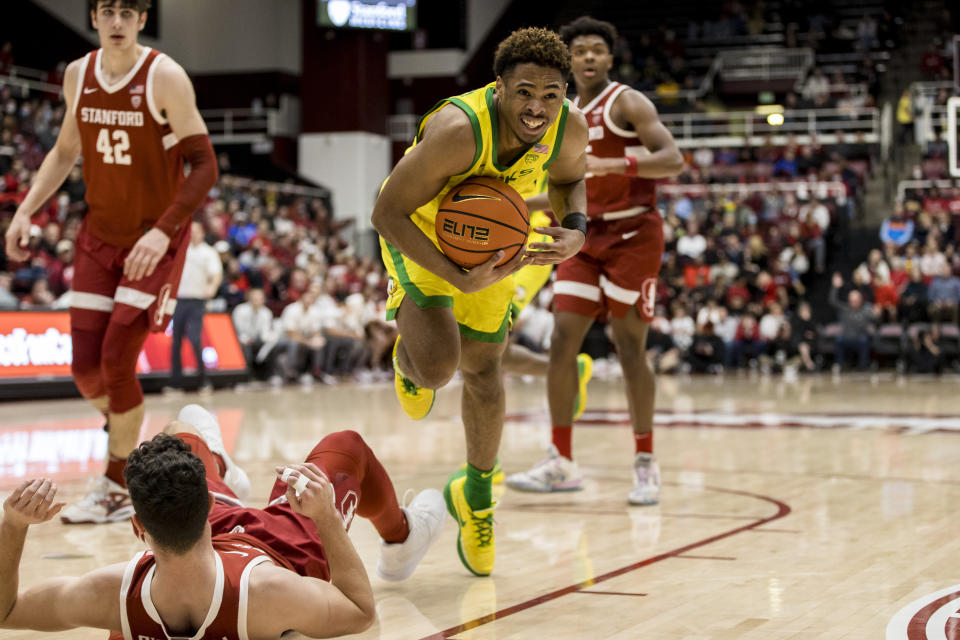 Oregon guard Keeshawn Barthelemy holds the ball after being fouled by Stanford guard Michael O'Connell, foreground, during the second half of an NCAA college basketball game in Stanford, Calif., Saturday, Jan. 21, 2023. Stanford won 71-64. (AP Photo/John Hefti)