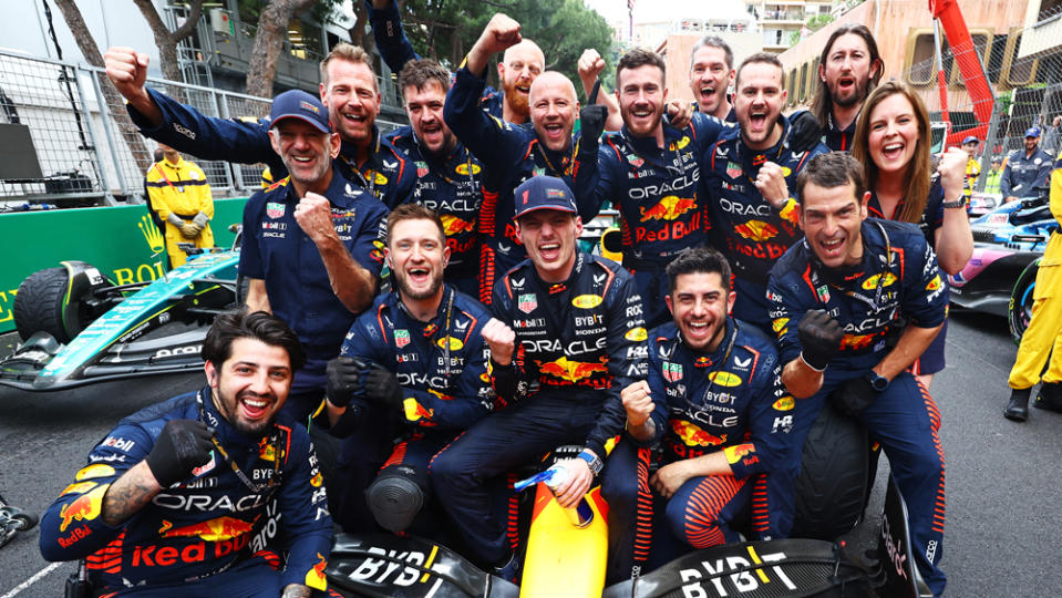 Members of the Oracle Red Bull Racing team pose with driver Max Verstappen after his win at the 2023 Monaco Grand Prix.