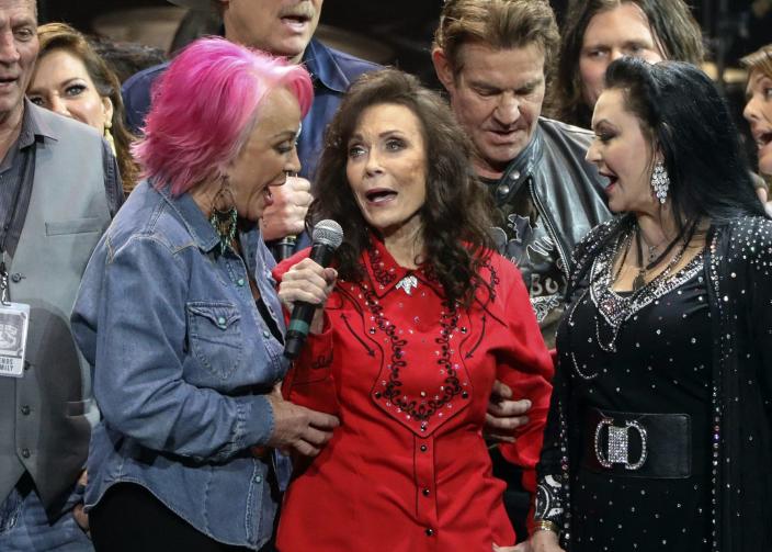 Loretta Lynn, center, Tanya Tucker, left, and Crystal Gayle perform at Loretta Lynn's 87th Birthday Tribute at Bridgestone Arena on Monday, April 1, 2019, in Nashville, Tenn.