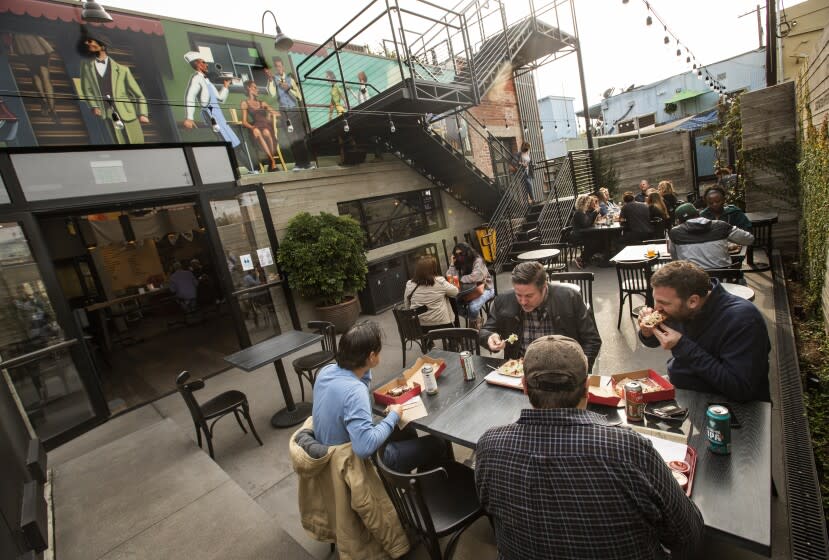 CULVER CITY, CA - November 19, 2021: Customers dine in the outside back patio at Citizen Public Market, Culver City's newest food hall. Located in a restored former publishing house, the two-story space features eight restaurants, with seating on its back patio and rooftop deck. (Mel Melcon / Los Angeles Times)