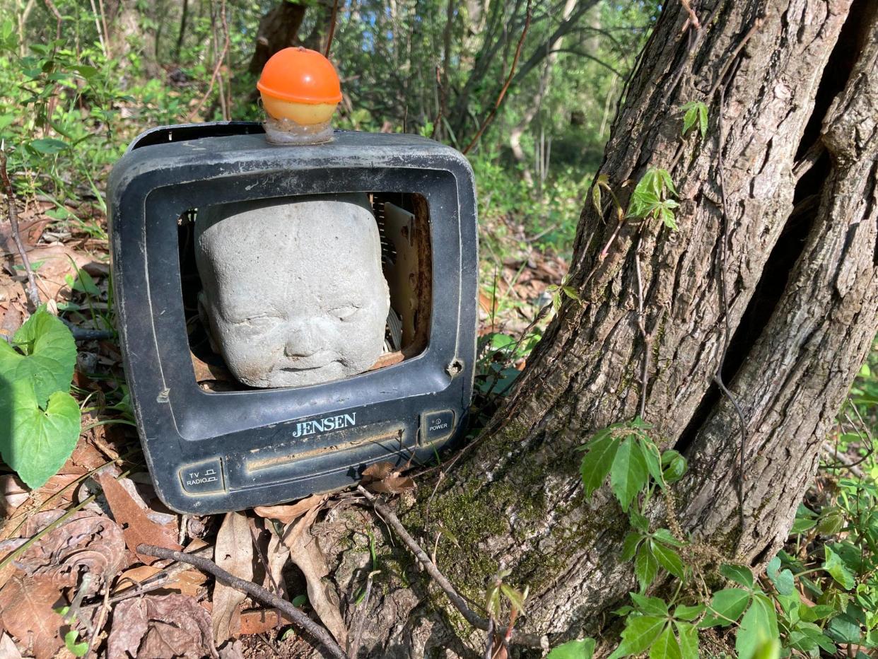 FILE - The Doll's Head Trail in Constitution Lakes Park in Atlanta is made up of a variety of found objects discovered at the park including bricks, old toys, signs, and dolls. Volunteers upkeep the trail to make sure people aren't bringing in outside objects to update the trail.