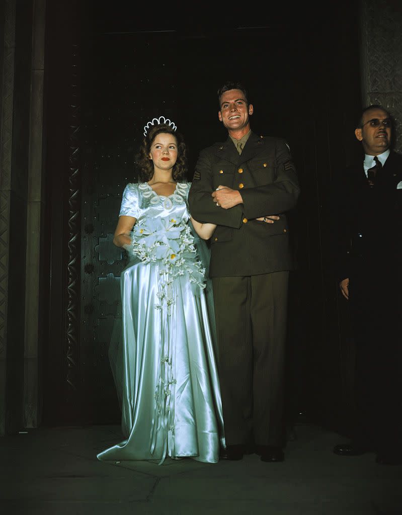 <p>When former child star Shirley Temple married Army Corps sergeant, John Agar, in 1945, it was an event that all of America wanted to witness. Her dress, a full-length stain gown with short sleeves, was on par with the fashion of the time, but the unusual beaded neckline and matching headpiece were far from typical. </p>