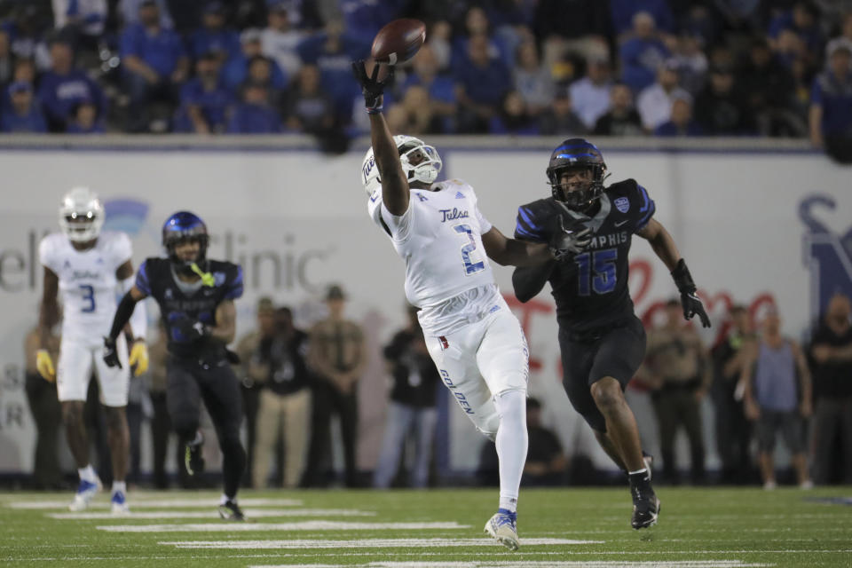 Tulsa wide receiver Keylon Stokes (2) reaches for a pass as he is defended by Memphis defensive back Quindell Johnson (15) during the first half of an NCAA college football game Thursday, Nov. 10, 2022, in Memphis, Tenn. (Patrick Lantrip/Daily Memphian via AP)