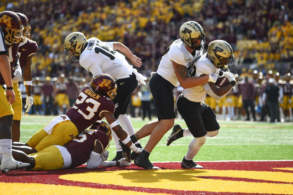 Purdue running back Dylan Downing, right, runs into the end zone for a touchdown, with the help of tight end Payne Durham, during the first half an NCAA college football game against Minnesota on Saturday, Oct. 1, 2022, in Minneapolis. (AP Photo/Craig Lassig)