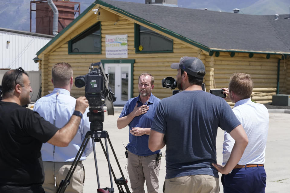 Lane Mugleston, the owner of Leap Ahead Daycare, speaks to reporters Tuesday, May 23, 2023, in Spanish Fork, Utah. A 2-year-old boy was shot in the head by a stray bullet while playing outside at day care in Utah, the facility's owner and authorities said. Spanish Fork police believe the bullet came from a pellet or air gun shot from a farming field across the street west of the facility, Lt. Clay Slaymaker said. (AP Photo/Rick Bowmer)