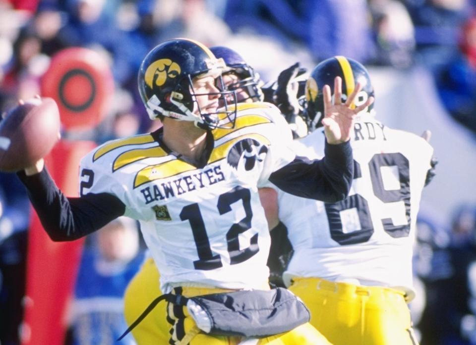 11 Nov 1995:  Quarterback Matt Sherman passes the ball as guard Matt Purdy of the Iowa Hawkeyes provides protection during a game against the Northwestern Wildcats at Dyche Stadium in Evanston, Illinois.  Northwestern won the game 31-20. Mandatory Credit: