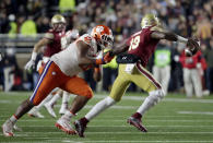 Clemson defensive lineman Christian Wilkins, left, tackles Boston College quarterback Anthony Brown during the first half of an NCAA college football game Saturday, Nov. 10, 2018, in Boston. (AP Photo/Elise Amendola)