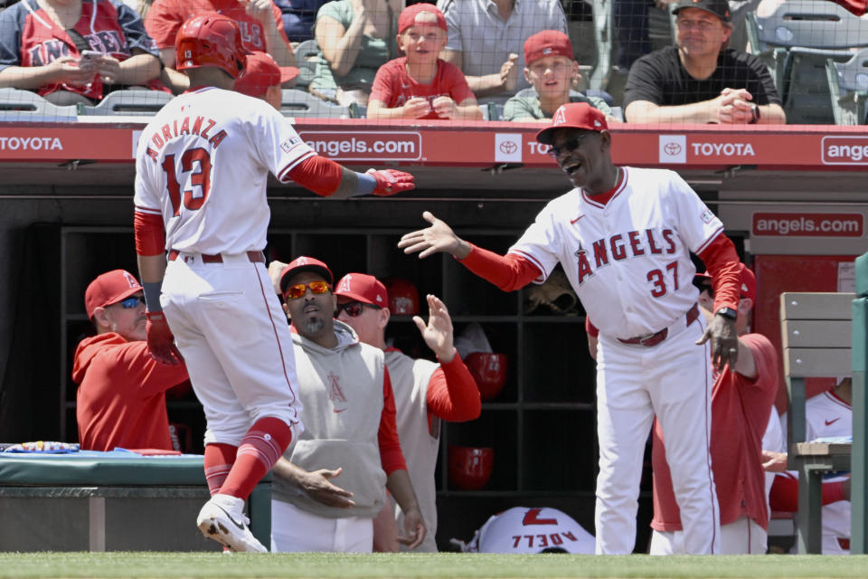 Los Angeles Angels manager Ron Washington (37) congratulates Ehire Adrianza (13) for hitting a solo home run during the second inning of a baseball game against the Philadelphia Phillies in Anaheim, Calif., Wednesday, May 1, 2024. (AP Photo/Alex Gallardo)