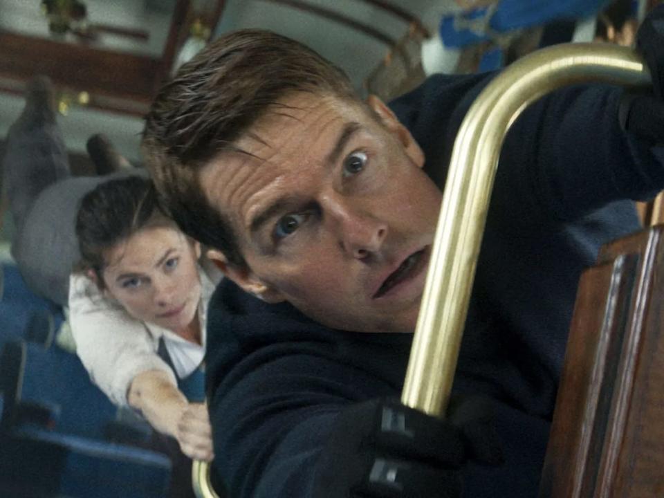 Hayley Atwell and Tom Cruise hanging in a train in "Mission: Impossible - Dead Reckoning Part One."