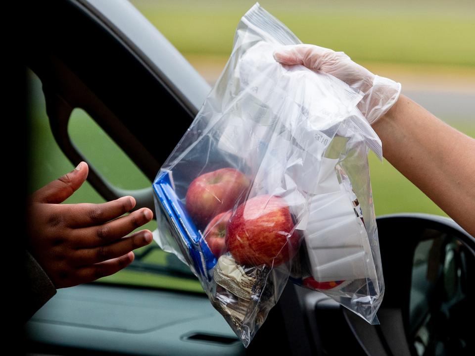 Schools across the country — including Prattville Intermediate School, shown here on March 18, 2020 — used off-site food distribution points to get meals in the hands of children who were attending virtual school during the COVID pandemic. An early 2022 Alabama state school board audit of Montgomery's LEAD Academy school meal program found problems with the school's claims for reimbursement and has demanded it return nearly $1.9 million, which it has already paid to its meal vendor.