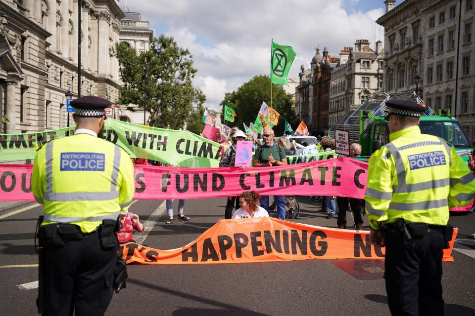 Climate activists from Extinction Rebellion during a protest outside the offices of HM Revenue and Customs (HMRC) (PA)
