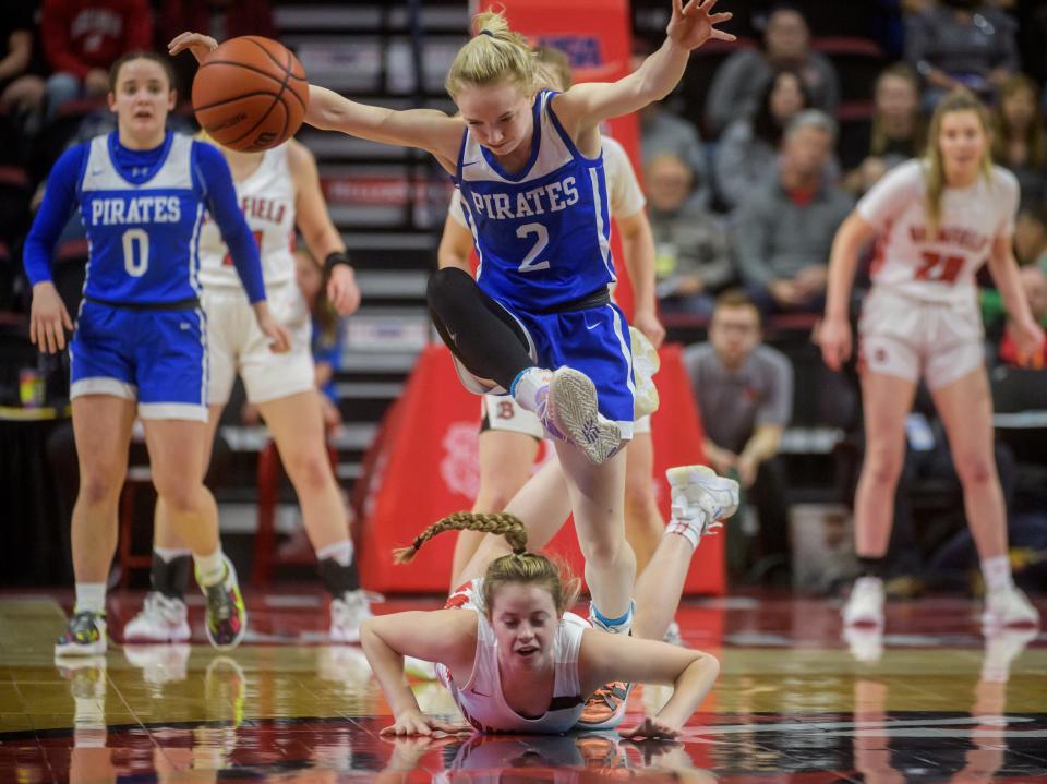 Galena's Gracie Furlong jumps over Brimfield's Sophie Bedell as they scramble for a loose ball in the first half of the Class 1A state title game Saturday, March 5, 2022 at Redbird Arena in Normal.