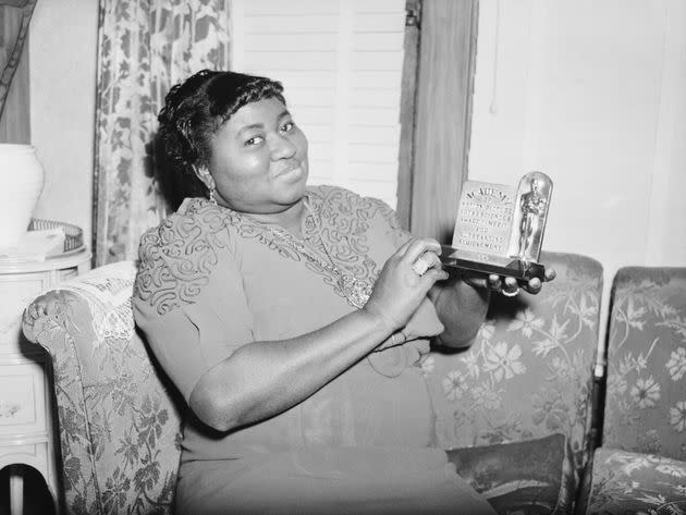 Hattie McDaniel poses with her Oscar plaque for Best Supporting Actress for 