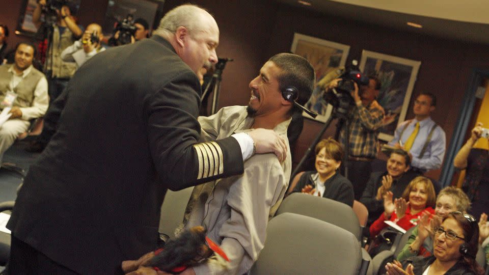 Rio Rico Fire Chief Michael M. Foster thanks Manuel Cordova during a ceremony on December 4, 2007, at the Dennis DeConcini Port of Entry in Nogales, Arizona. At right is Cordova's mother, Alma Lidia Soberanes. Foster also gave Cordova a small stuffed horse, telling him he’d been a hero in the wilderness, like the Lone Ranger. - Jeffry Scott/Arizona Daily Star