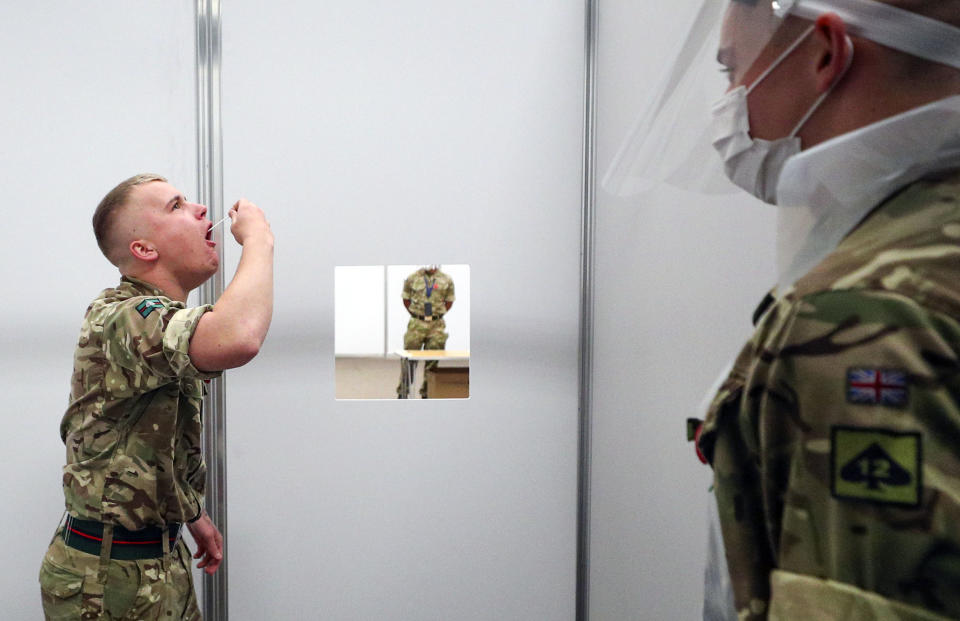 Soldiers practice on themselves at the Liverpool Tennis Centre in Wavertree, before the start of the mass Covid-19 testing in Liverpool. (Photo by Peter Byrne/PA Images via Getty Images)