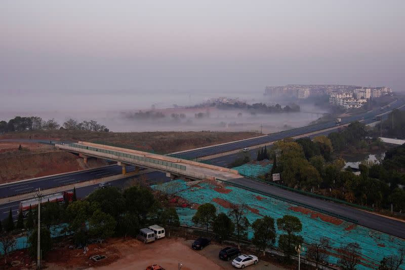 FILE PHOTO: A fishing village is seen next to a highway at Poyang lake, China