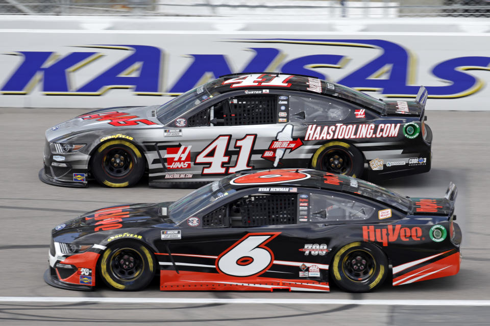 Cole Custer (41) and Ryan Newman (6) head toward turn one during a NASCAR Cup Series auto race at Kansas Speedway in Kansas City, Kan., Sunday, May 2, 2021. (AP Photo/Colin E. Braley)