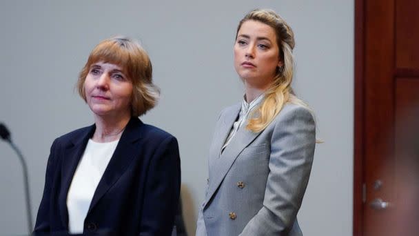 PHOTO: Actor Amber Heard stands with her attorney attorney Elaine Bredehoft before closing arguments in the Depp v. Heard trial at the Fairfax County Circuit Courthouse in Fairfax, Virginia, May 27, 2022. (Steve Helber/AFP via Getty Images, FILE)