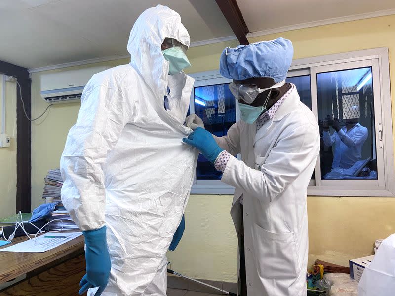 A medical staff wears protective gear at a new section specialised in receiving any person who may have been infected with coronavirus at The Quinquinie Hospital in Douala,