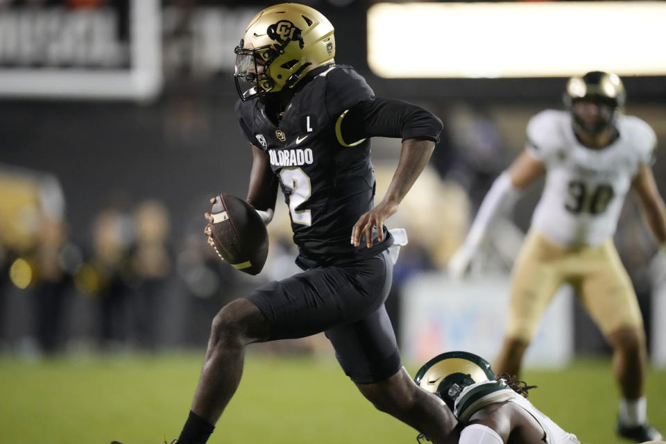 Colorado quarterback Shedeur Sanders, left, is pulled down by Colorado State defensive lineman Tony Pierce Jr. in the second half of an NCAA college football game Saturday, Sept. 16, 2023, in Boulder, Colo. (AP Photo/David Zalubowski)