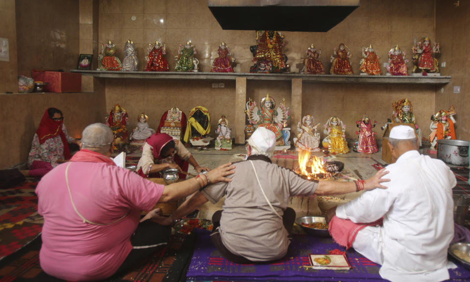 Kashmiri Hindu perform rituals during the annual festival at Kheer Bhawani temple amid the Coronavirus pandemic in Jammu, India, Saturday, May 30, 2020. The festival was marked in a low key manner due to the lockdown to prevent the spread of the  new coronavirus. (AP Photo/Channi Anand)