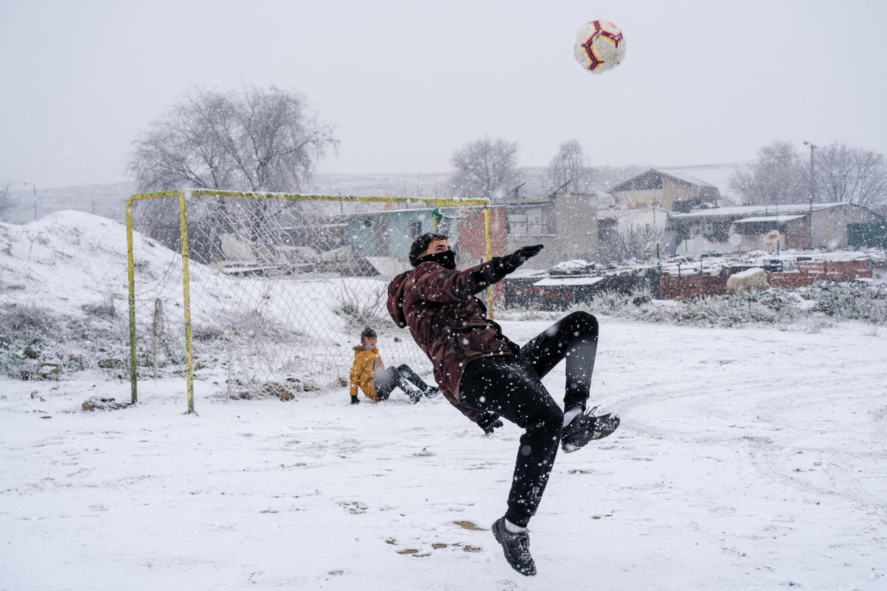  A young man playing soccer in the La Ca�ada Real neighbourhood during heavy snowfall. Spain registers historical low temperatures and snowfalls putting the community of Madrid on alert. In the south of Madrid, La Ca�ada Real, the community has been deprived of electricity for 3 months. (Photo by Diego Radames / SOPA Images/Sipa USA) 