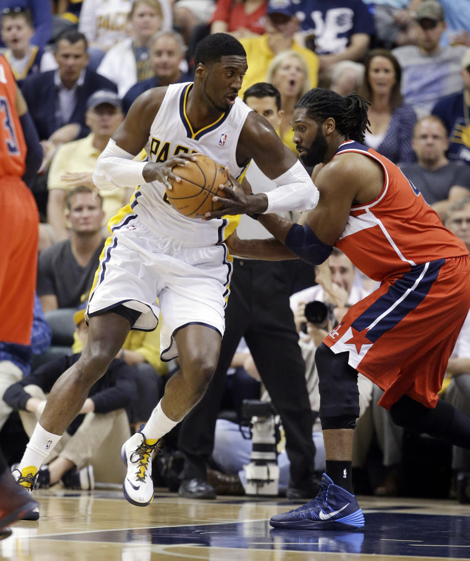 Indiana Pacers center Roy Hibbert, left, drives on Washington Wizards forward Nene Hilario during the first half of game 2 of the Eastern Conference semifinal NBA basketball playoff series Wednesday, May 7, 2014, in Indianapolis. (AP Photo/Darron Cummings)