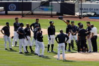 New York Yankees pitcher Masahiro Tanaka, right, is tended to by team medical personnel after being hit by a ball off the bat of Yankees Giancarlo Stanton during a baseball a workout at Yankee Stadium in New York, Saturday, July 4, 2020. (AP Photo/Adam Hunger)