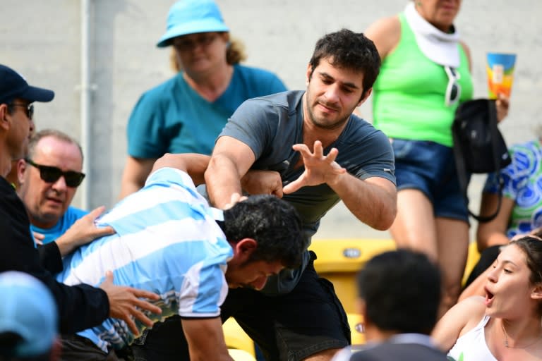 An Argentinian fan fights with another fan at the match between Argentina's Juan Martin Del Potro and Portugal's Joao Sousa in Rio on August 8, 2016