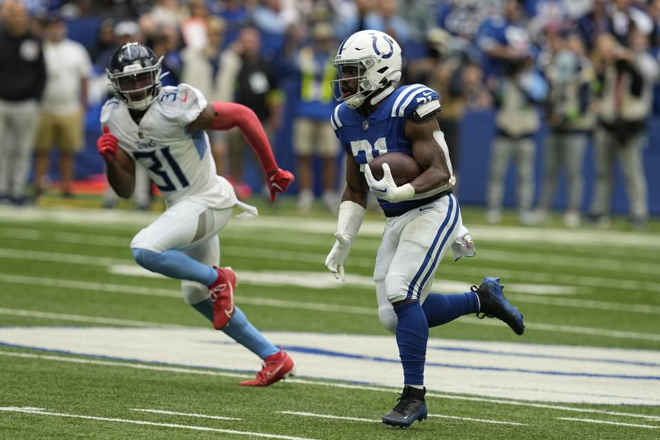Indianapolis Colts running back Zack Moss, right, runs for a 56-yard touchdown past Tennessee Titans safety Kevin Byard (31) during the first half of an NFL football game, Sunday, Oct. 8, 2023, in Indianapolis. | Darron Cummings, Associated Press