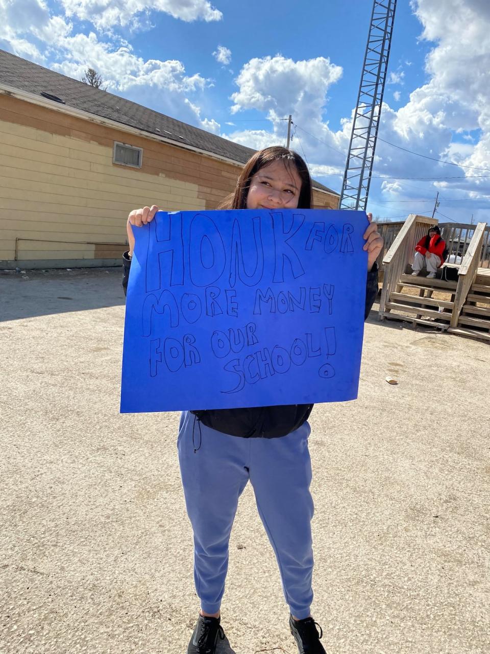 Students also held signs in support of receiving more money for their school.