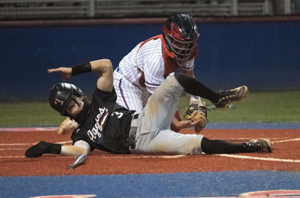 Pace catcher Clifford Musgrove gets the out as Tates' Frankie Randall fails to score against the Patriots during Friday night's game. 
