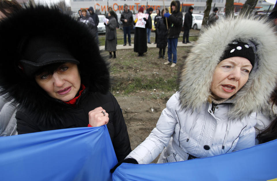 Crimean Tatars shout slogans during the pro Ukraine rally in Simferopol, Crimea, Ukraine, Monday, March 10, 2014. Russian President Vladimir Putin on Sunday defended the separatist drive in the disputed Crimean Peninsula as in keeping with international law, but Ukraine's prime minister vowed not to relinquish "a single centimeter" of his country's territory. The local parliament in Crimea has scheduled a referendum for next Sunday. (AP Photo/Darko Vojinovic)