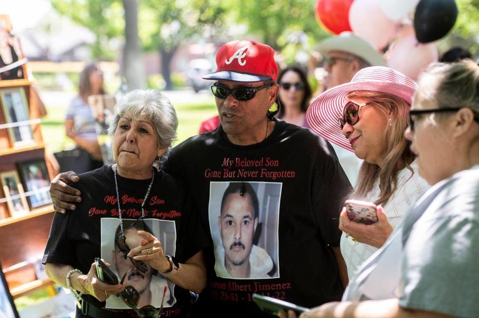 Merced residents Lucy Garcia, left, and Raul Garcia, right, look at photos of victims of violent crimes during the Merced County Victims’ Rights Ceremony at Courthouse Park in Merced, Calif., on Tuesday, April 25, 2023. Lucy’s oldest child and Raul’s stepson, Aaron Albert Jimenez, 41, was shot and killed on Dec. 11, 2022 in Merced. The annual event held to remember victims of violence and crime, is hosted by the Merced County District Attorney’s Office during National Crime Victims’ Rights Week.