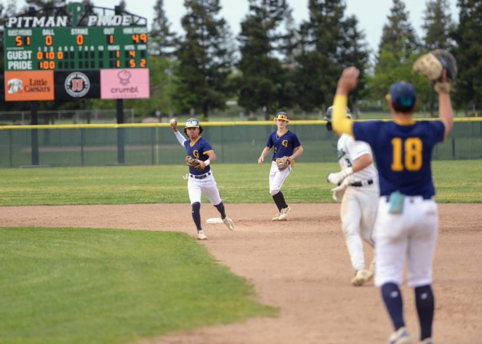 Gregori infielders Izaia Perez and Lance Eastman attempt to chase down Pitman’s Ryder Scott during a CCAL matchup at Pitman High School in Turlock, Calif. on Wednesday, April 24, 2024.