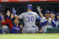 Texas Rangers' Nathaniel Lowe is congratulated in the dugout after hitting a two-run home run against the Los Angeles Angels during the seventh inning of a baseball game in Anaheim, Calif., Saturday, Oct. 1, 2022. (AP Photo/Ringo H.W. Chiu)