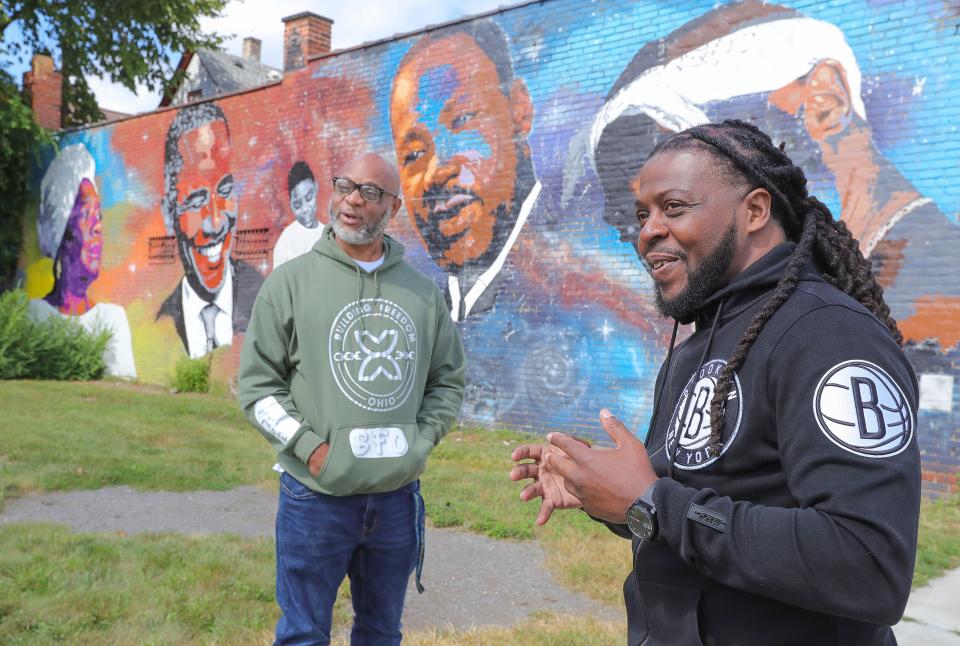 Collateral Sanctions organizer Ronald Crosby, left, talks with Tasmone Taylor outside of the Khnemu Foundation Lighthouse Center in Cleveland.