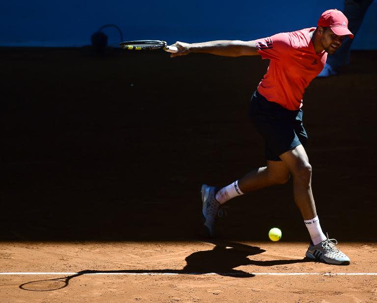 French tennis player Jo-Wilfried Tsonga returns the ball to Czech tennis player Lukas Rosol during day four of the Madrid Open tournament at the Caja Magica (Magic Box) sports complex in Madrid on May 5, 2015